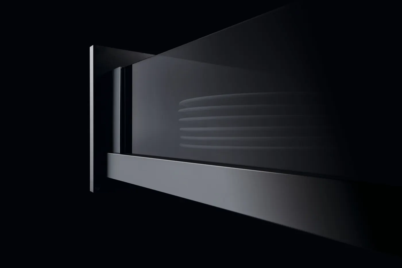 Close view of a glass-sided Crystal Plus drawer with a metal rail and plates visible through the glass, in a dark setting