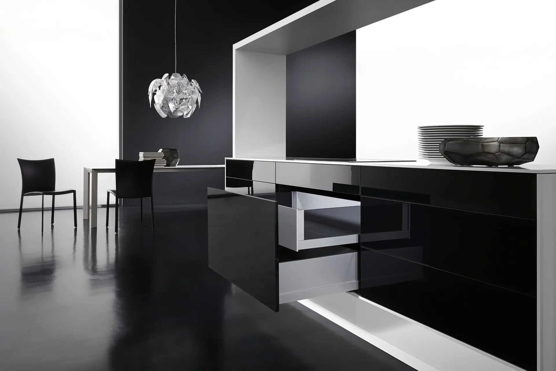 Black gloss modular kitchen island with a soft-close drawer pulled open to show a metal-sided drawer box