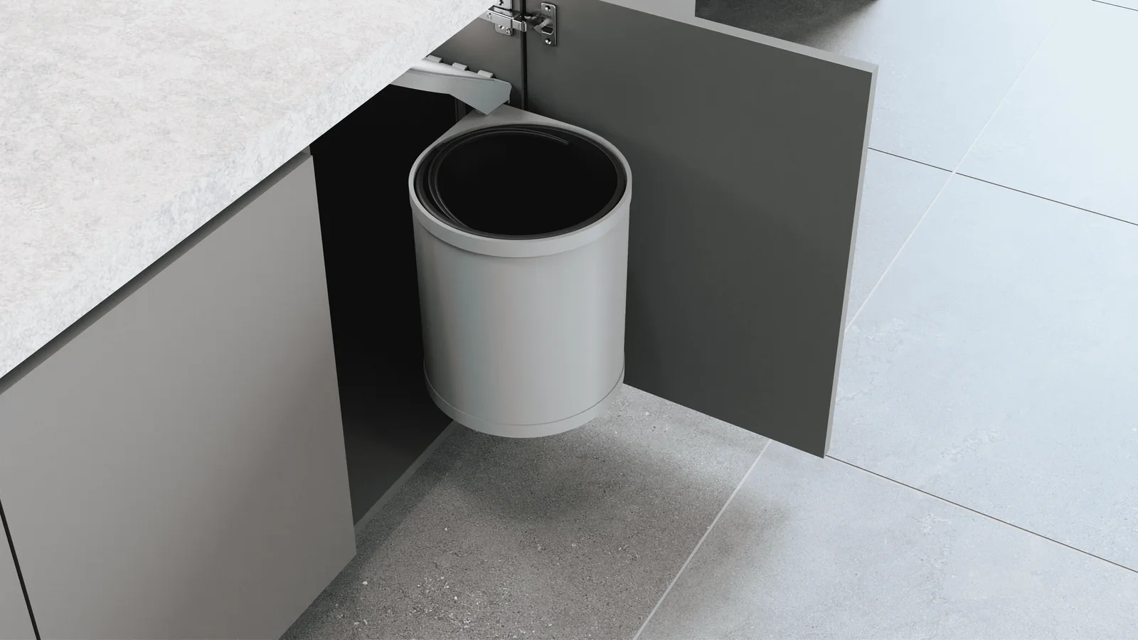Ring rotating waste bin Ring round rotating waste bin mounted inside a modular kitchen base cabinet beside the open door